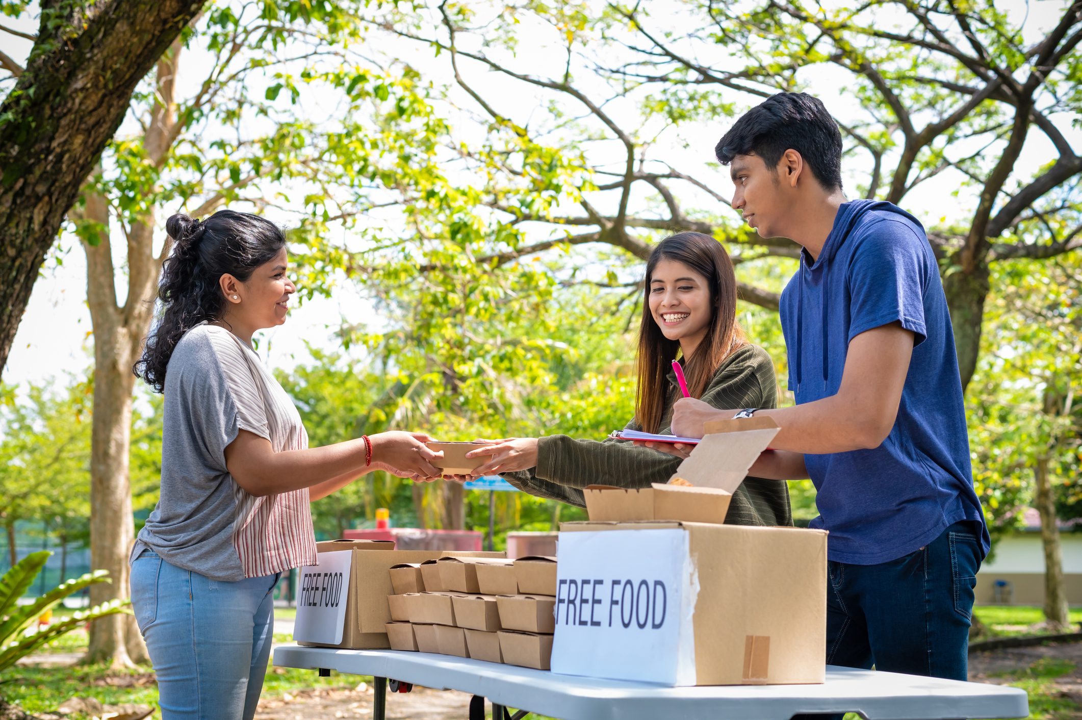 Volunteers handing out meals at park