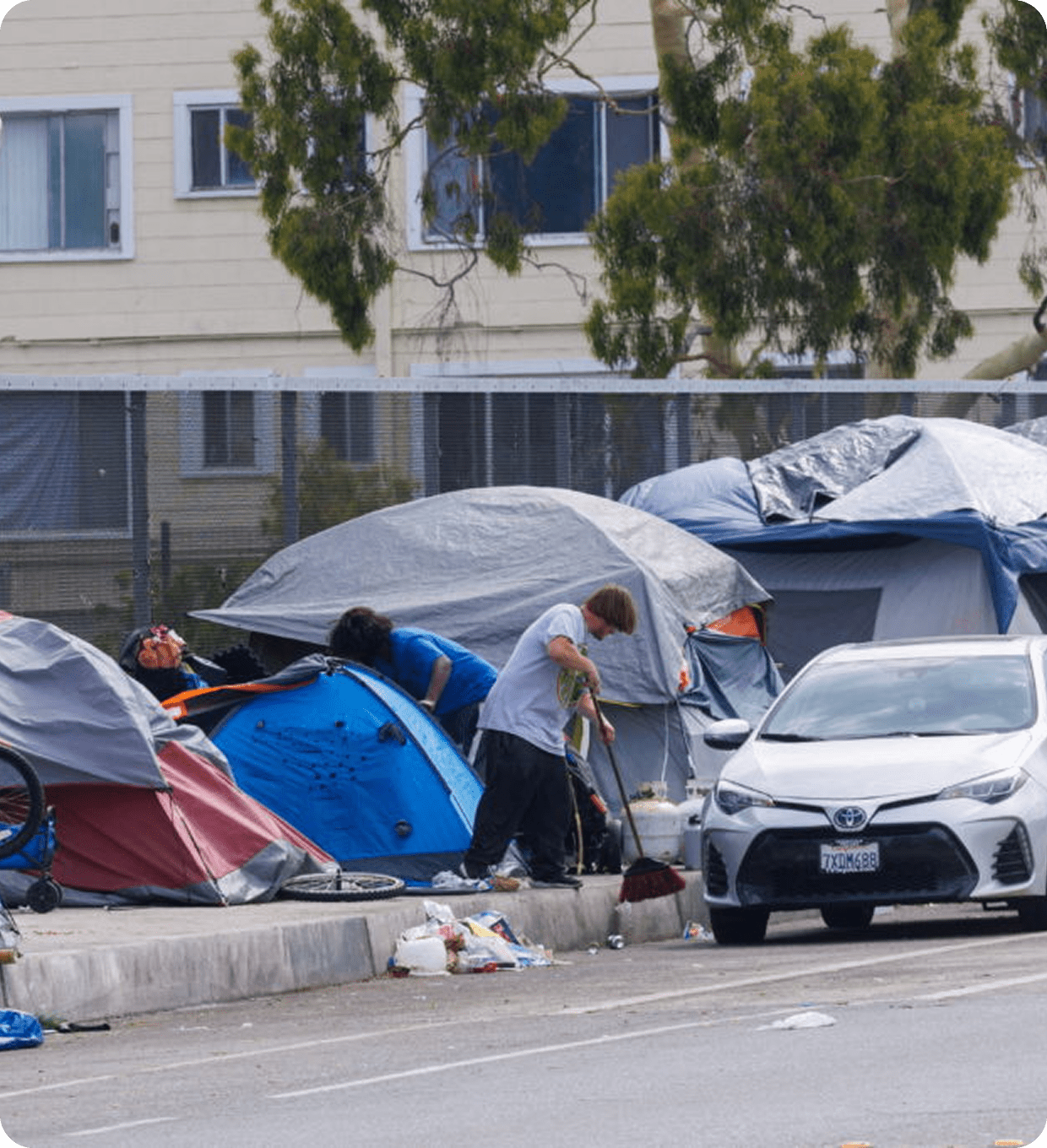Temporary shelters and parked car nearby