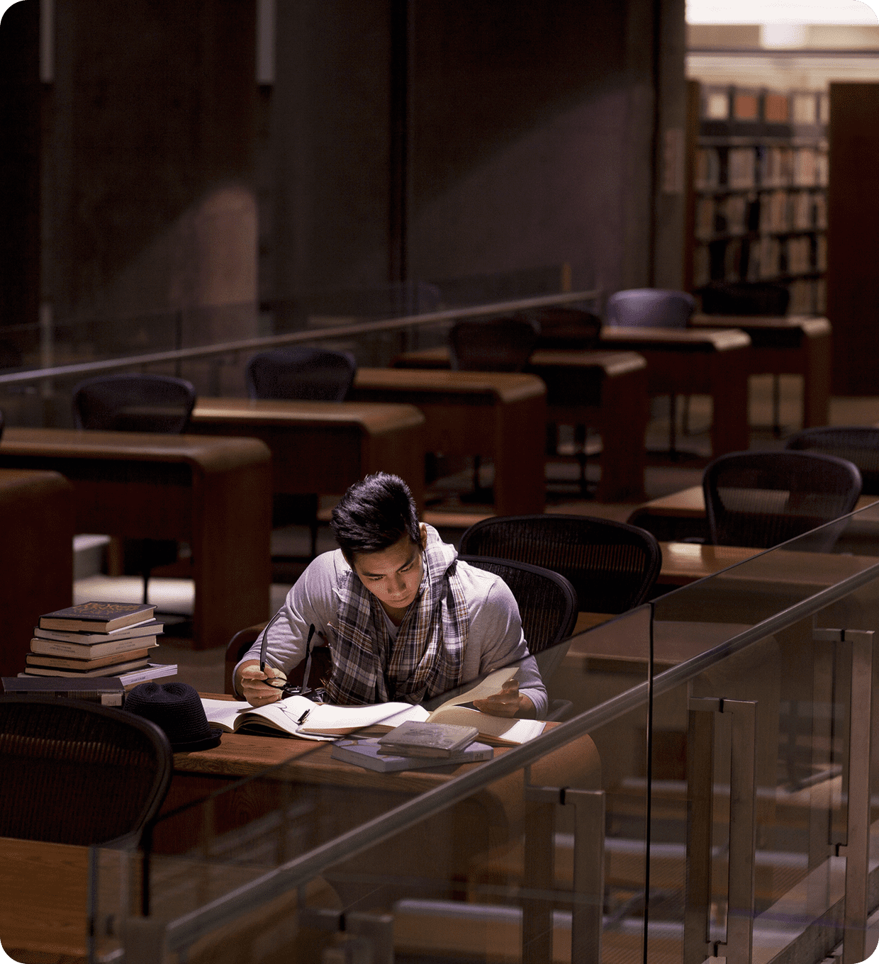 Student studying alone in library