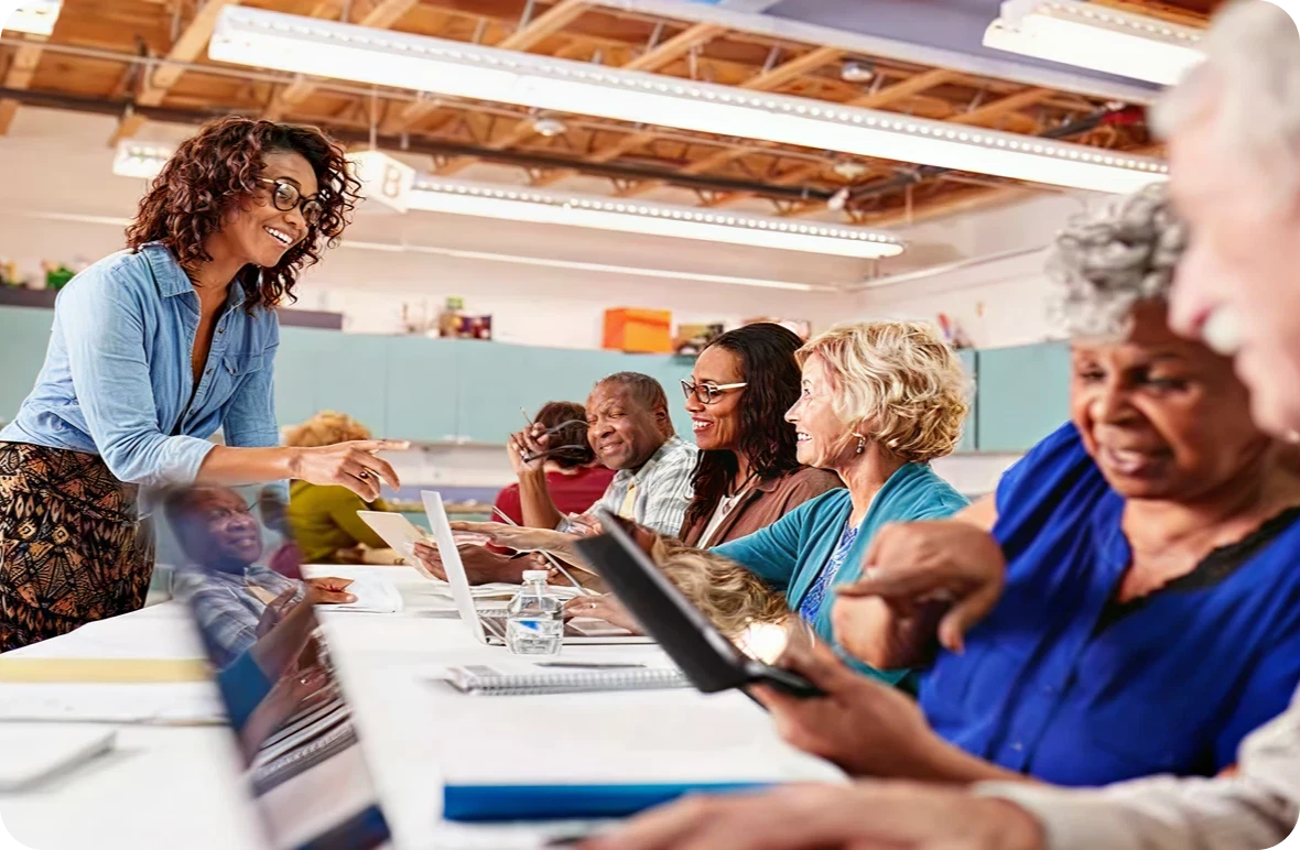 Teacher assisting seniors in technology class