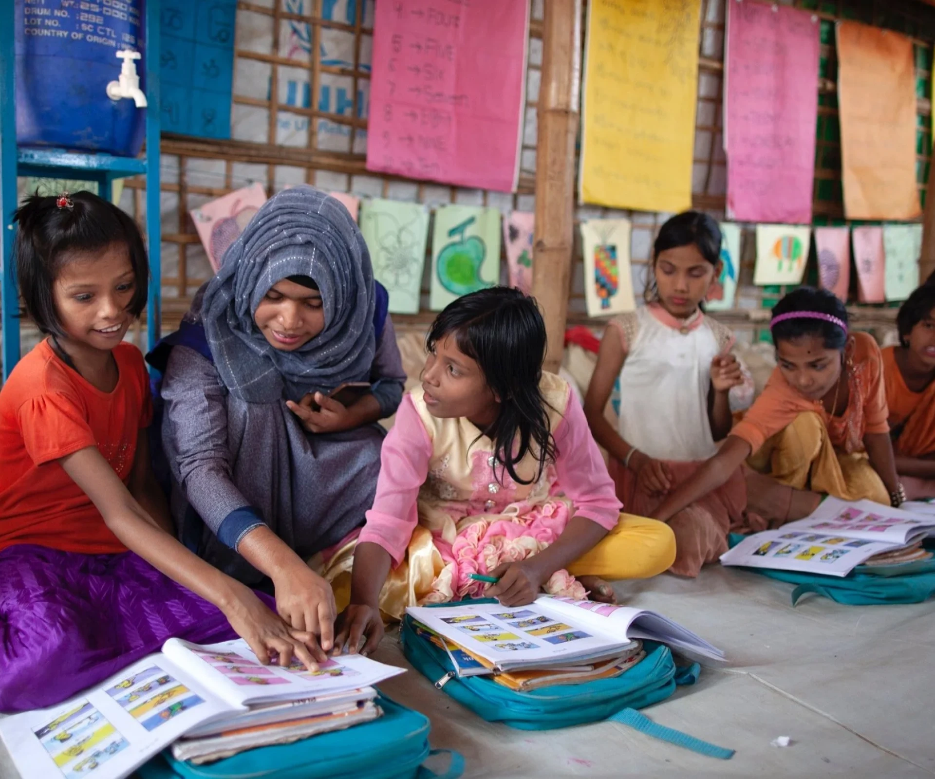 Students reading books on the floor
